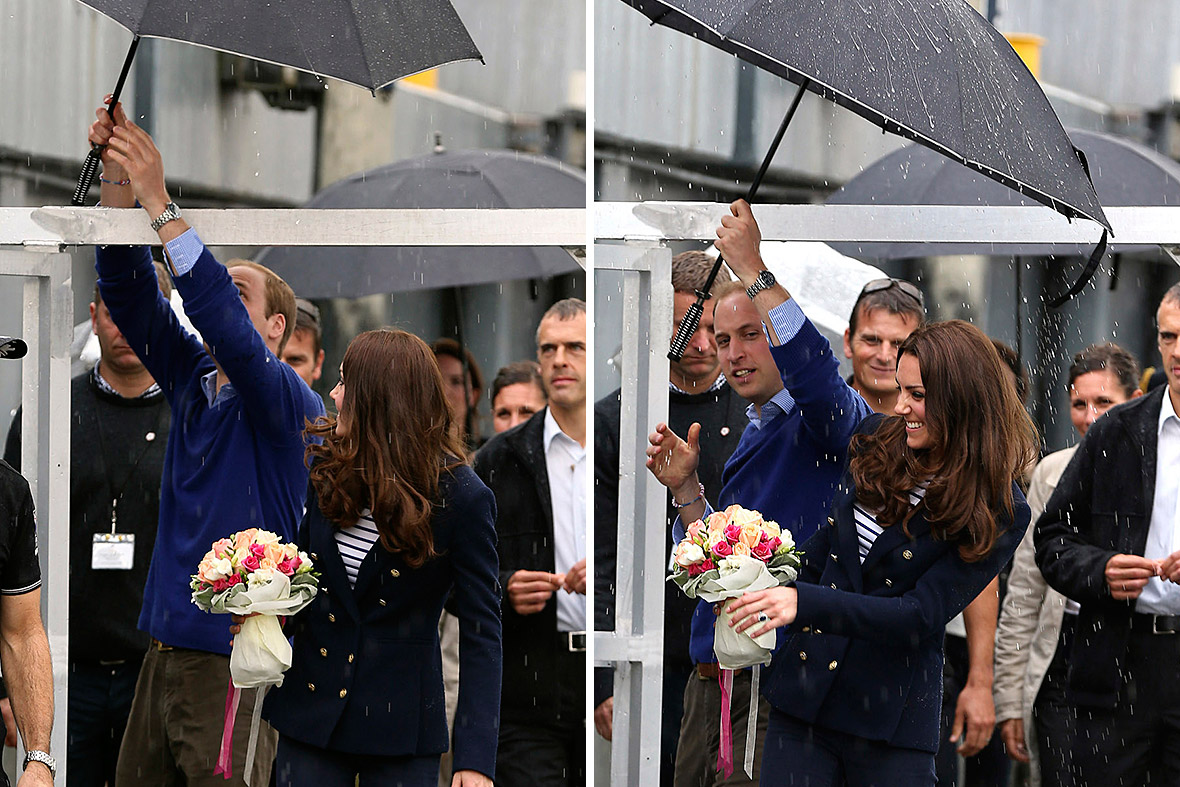 Prince William holds an umbrella above his wife and then spills water on her before boarding two America's Cup yachts on Auckland Harbour