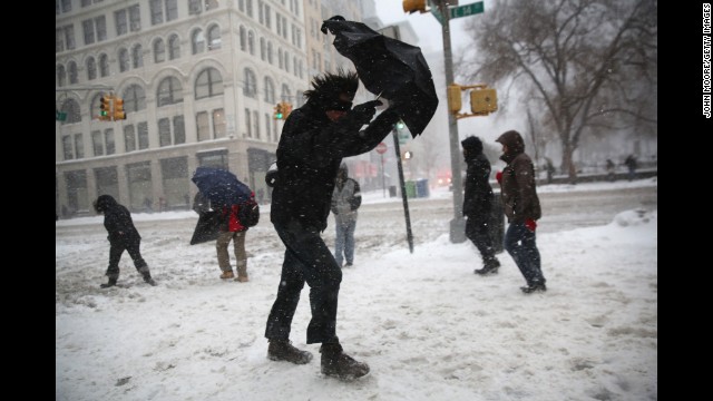 A man braces his umbrella while walking through the wind and snow in New York City on February 13.