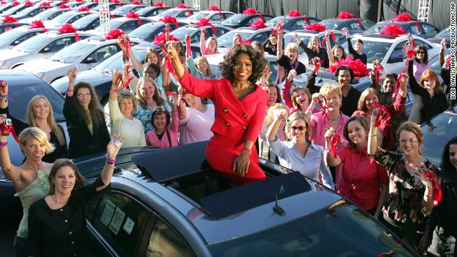 One of Chicago's most famous residents, Oprah Winfrey, sits atop a brand new car -- one of hundreds that she gave away to audience members in 2004 -- outside her Chicago studios. Winfrey moved her talk show to Chicago's West Loop in 1988, purchasing an 88,000-square-foot facility in the neighborhood, which was struggling at the time. She is now reportedly considering selling Harpo Studios, which helped revitalize the neighborhood.