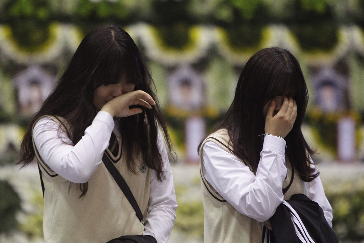 Students from Danwon high school weep after paying tribute at a group memorial altar for victims of the South Korean ferry disaster