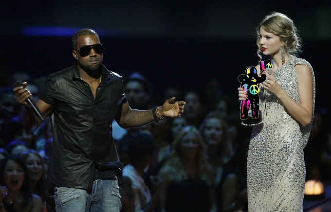 Singer Kanye West takes the microphone from singer Taylor Swift as she accepts the "Best Female Video" award during the MTV Video Music Awards on Sunday, Sept. 13, 2009 in New York. (AP Photo/Jason DeCrow) NYJC123