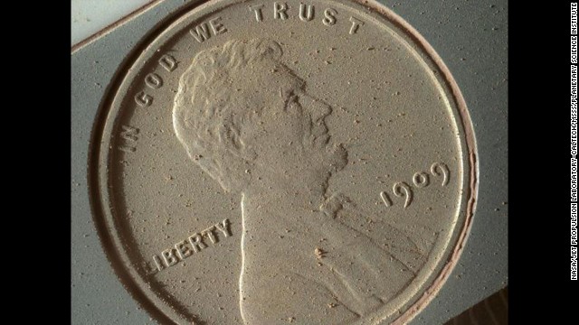 Martian dust appears on the surface of a penny that was brought along with the Curiosity rover and photographed by the <a href='http://ift.tt/1aD50TE' target='_blank'>Mars Hand Lens Imager</a> on October 2. The image of the 1909 coin is at the highest resolution possible for the high-powered camera -- 14 micrometers per pixel (a micrometer is about .000039 inches). 