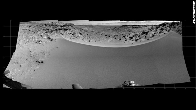 This mosaic of images from the Navigation Camera on Curiosity shows the terrain to the west from the rover's position on the 528th Martian day, or sol, of the mission on January 30. The images were taken right after Curiosity had arrived at the eastern edge of a location called "Dingo Gap." A dune across the gap is about 3 feet high in the middle and tapered at south and north ends onto low scarps on either side of the gap. The rover team is evaluating possible driving routes on the other side before a decision whether to cross the gap. The view covers a panorama from south, at the left edge, to north-northwest at the right edge. It is presented as a cylindrical projection.