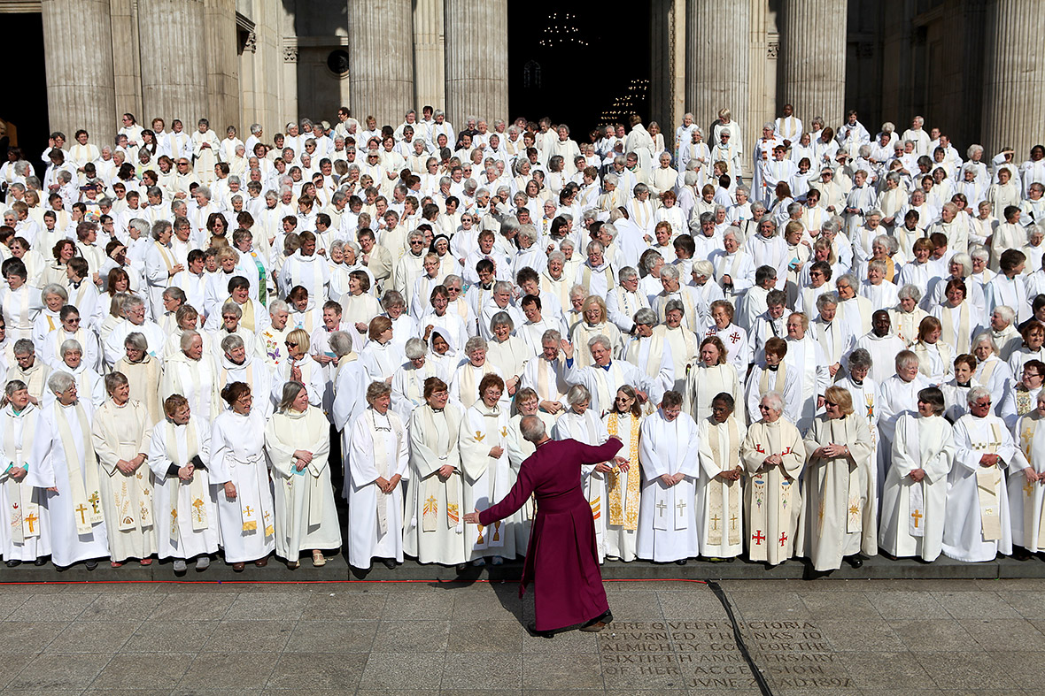 The Archbishop of Canterbury, Justin Welby, jokes with a crowd of women priests on the steps of St Paul's Cathedral before a special service to mark 20 years since women were first allowed to be ordained as priests.