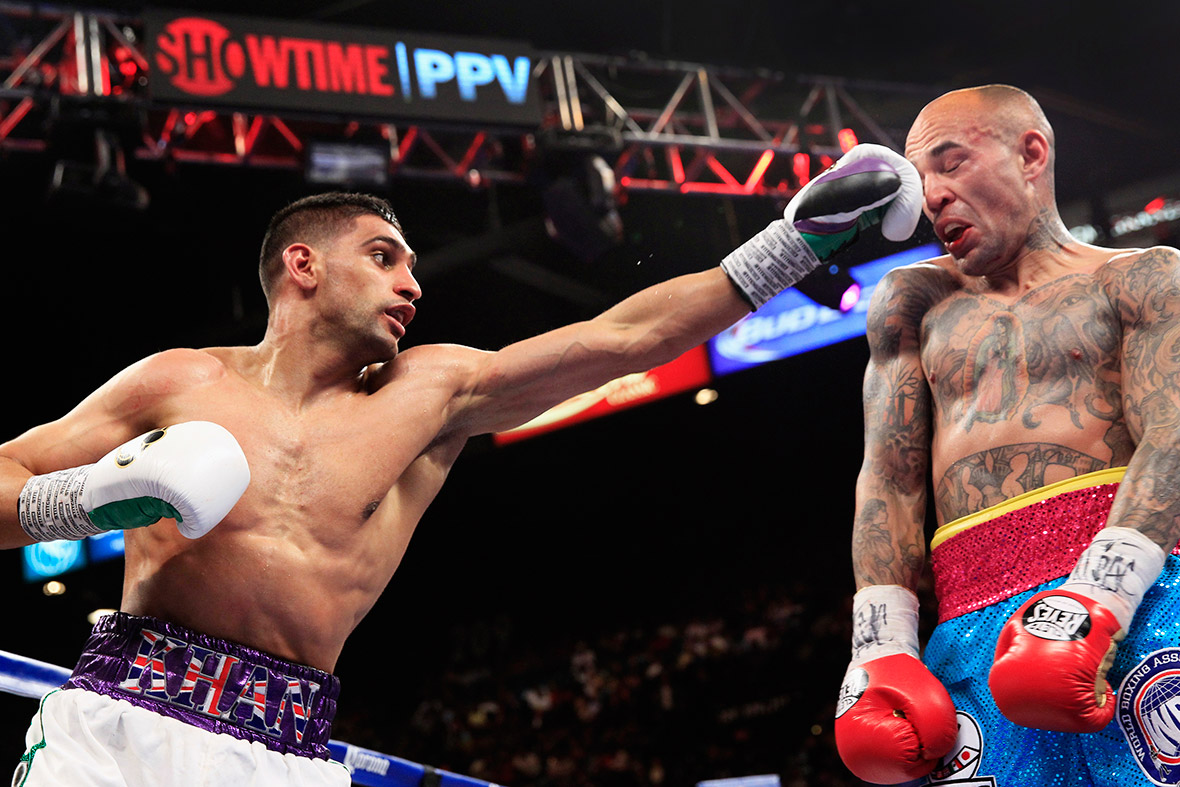 Amir Khan of Britain punches Luis Collazo of the US during their welterweight fight at the MGM Grand Garden Arena in Las Vegas.