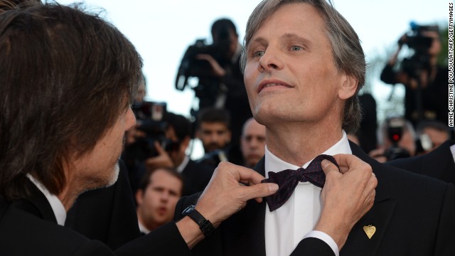 Brazilian director Walter Salles, left, adjusts Viggo Mortensen's bow tie at the 65th Cannes film festival in May 2012. Moretensen is 54.