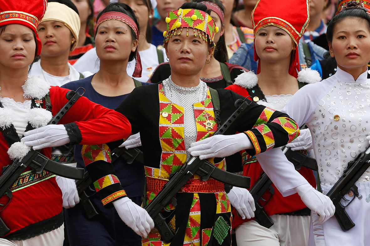 Vietnamese female militants, dressed in ethnic minorities costumes, hold rifles while marching during the 60th anniversary celebrations of the Dien Bien Phu battle.