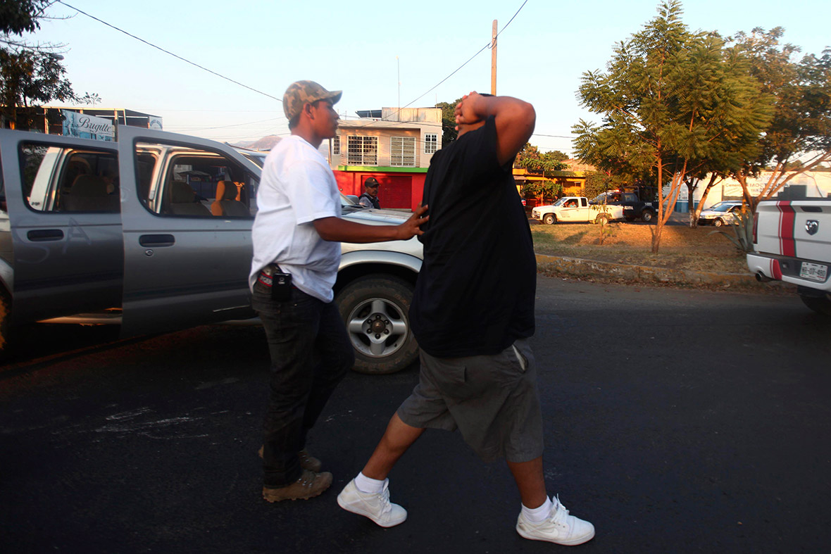 A vigilante arrests a suspect in Apatzingan, considered the centre of operations of drug cartel Knights Templar