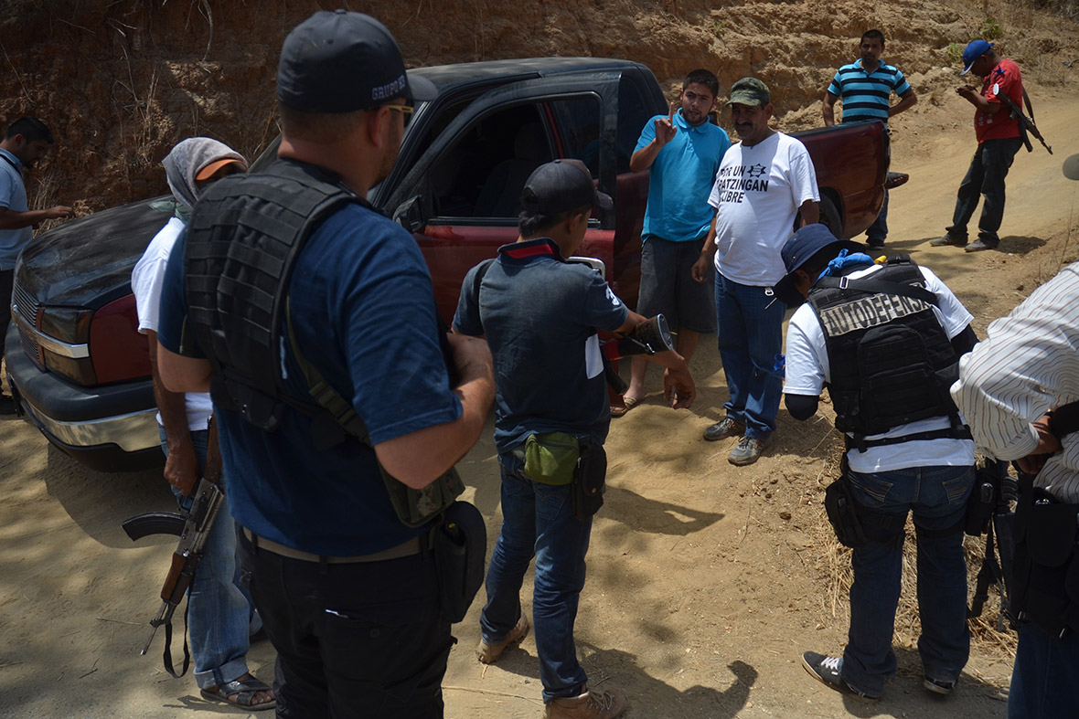 Vigilantes argue with the driver of a pickup truck after they heard music associated with the Knights Templar playing from his vehicle, on the outskirts of Arteaga