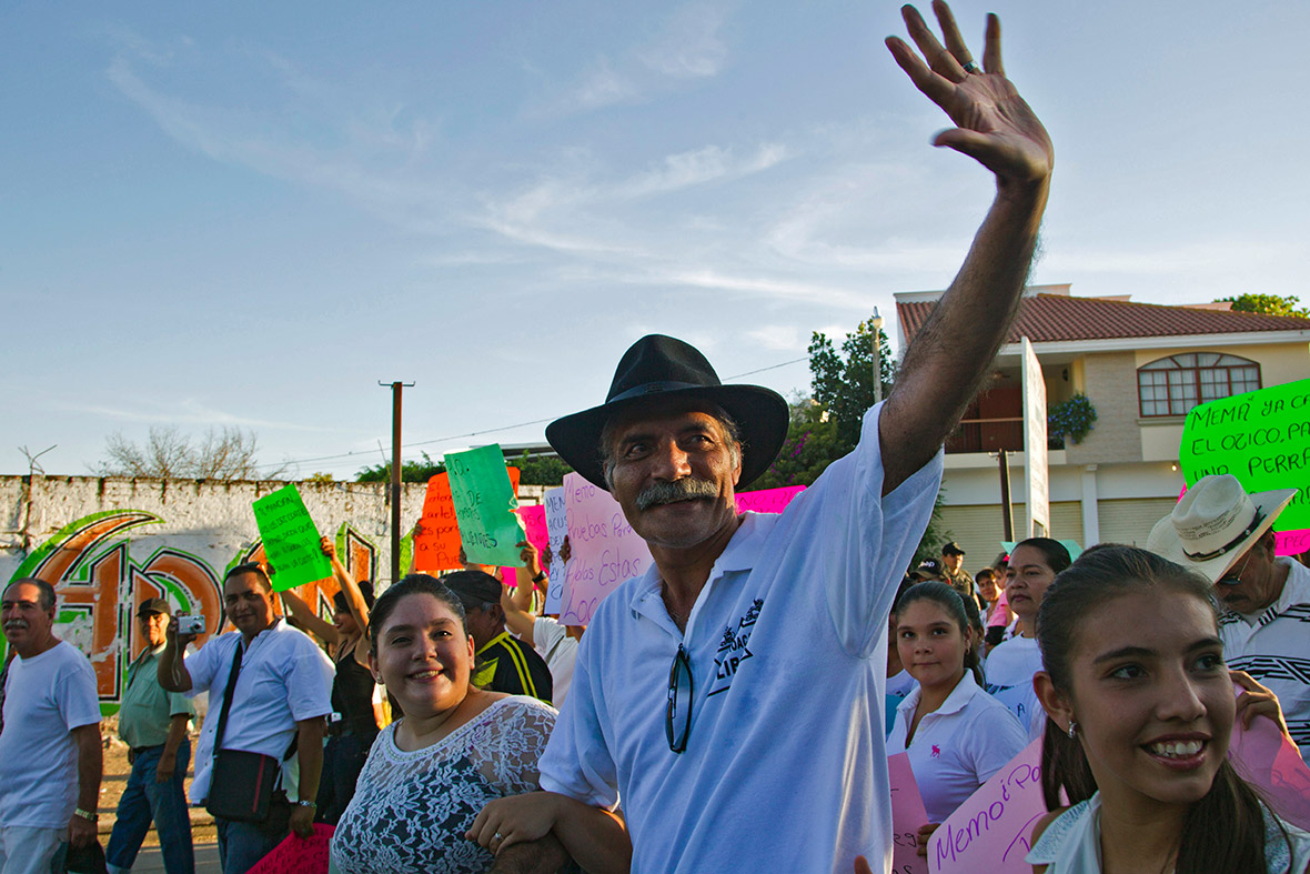 Jose Manuel Mireles, a leader of the vigilantes' Self-Protection Police, waves during a march to celebrate the first anniversary of the formation of the group of civilians who took arms to fight the drug cartels