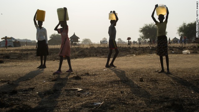 Internally displaced children carry water in Minkammen on January 10.