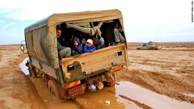 The road from the border to the camp is unpaved; here a Jordanian truck is stuck in the mud after recent spells of rain. The truck had to be pulled out of the mud by an armored personnel carrier.