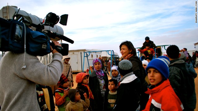 Children arriving at the base camp were overjoyed to see a playground, but after registering as refugees they still face a 400 kilometer drive to the Zaatari refugee camp.