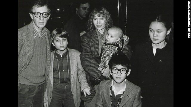 Mia Farrow has had 15 children, including three biological offspring with former husband composer Andre Previn, son Satchel (later known as Ronan) born during her relationship with Allen and several children she adopted. Here, she poses with Allen and her children, from left, Misha, Dylan (in Farrow's arms), Fletcher, and Soon-Yi in New York in 1986. The man in center background is unidentified. 