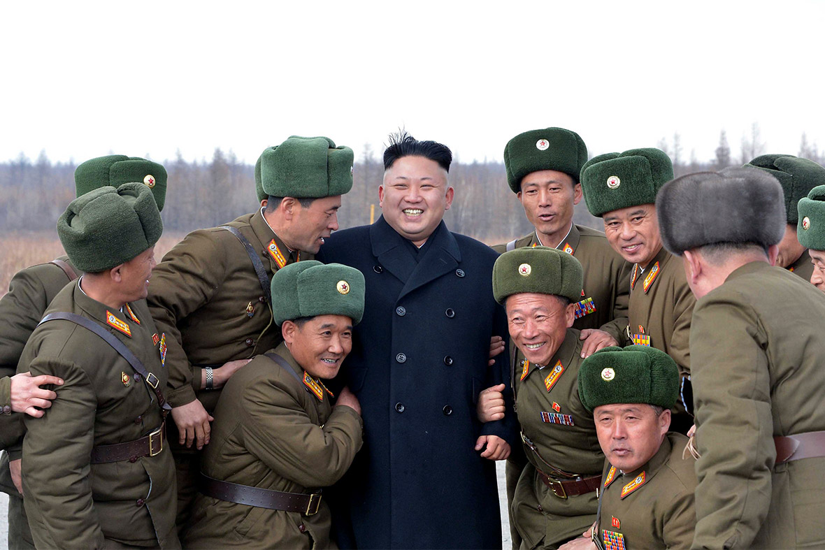 North Korean leader Kim Jong Un smiles as he is surrounded by commanding officers of the combined units of the Korean People's Army