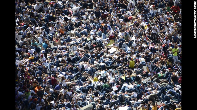 Thousands of students lie on the ground during a protest in front of the Venezuelan Judiciary building in Caracas on February 15.
