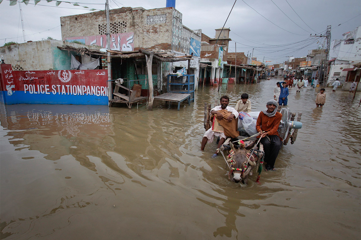 Residents use a donkey cart to transport their belongings out of the flooded Pangrio town in Pakistan's Sindh province on September 14, 2011. Unprecedented torrential monsoon rains caused flooding that killed more than 400 people and damaged 1.5 million homes