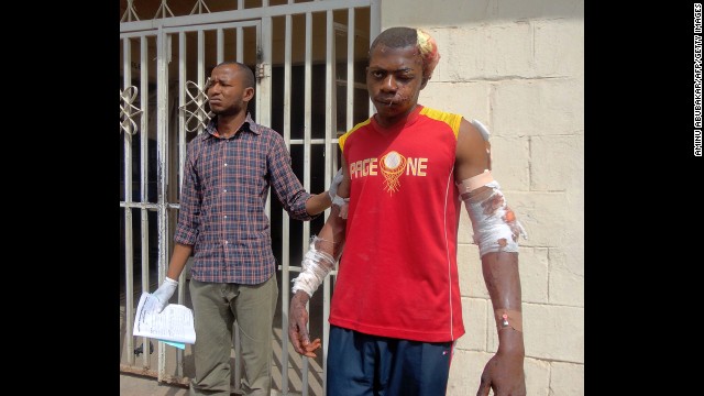 A paramedic helps a young man injured during one of the multiple explosions and shooting attacks as he leaves a hospital in the northern city of Kano on January 21, 2012. A spate of bombings and shootings left more than 200 people dead in Nigeria's second-largest city. Three days later, a joint military task force in Nigeria <a href='http://ift.tt/Rpfqxn'>arrested 158 suspected members</a> of Boko Haram.