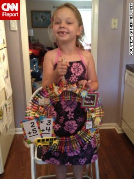 Katherine Linzey's 6-year-old daughter, Elyse, poses with a crayon wreath made as an end-of-year gift for her kindergarten teacher last year.