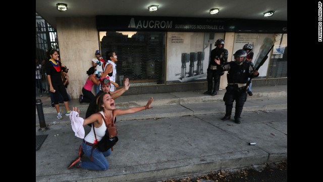 A demonstrator shouts for riot police not to fire tear gas in Caracas on Saturday, February 15.