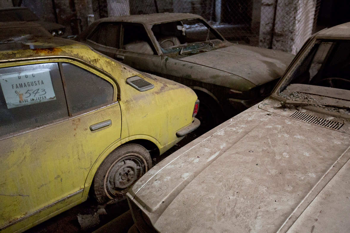 Cars sit abandoned in an underground garage in the United Nations buffer zone