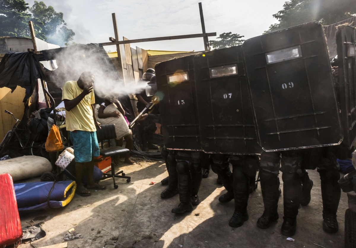 Armed police fire pepper spray in efforts at slum clearance in Brazil