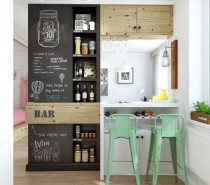 A bar area has been devised as the dividing wall between the lounge and kitchen areas, complete with quirky blackboard feature wall and flip-up bar surface.