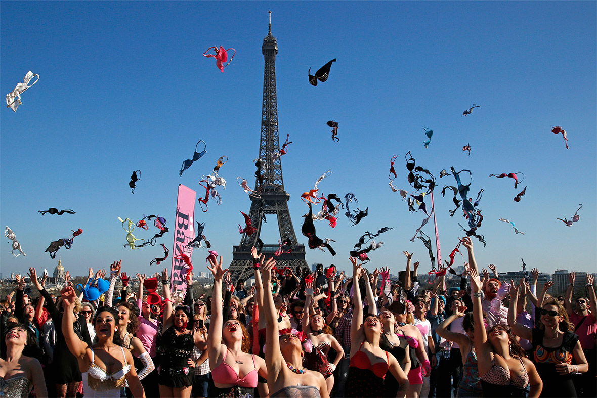 Women toss their bras into the air during the Pink Bra Spring Toss near the Eiffel Tower in Paris to support Pink Bra Bazaar, a charity dedicated to breast health education and supporting women diagnosed with breast cancer