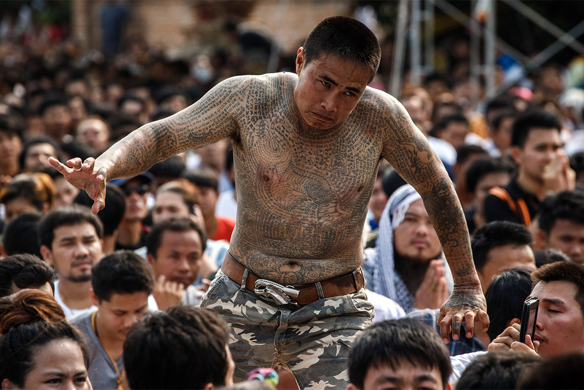 A devotee takes part in the annual Magic Tattoo Festival at Wat Bang Phra in Nakhon Prathom province, Thailand. People flock to the monastery to have their bodies adorned by the temple's master tattooist. They believe the tattoos have mystical powers