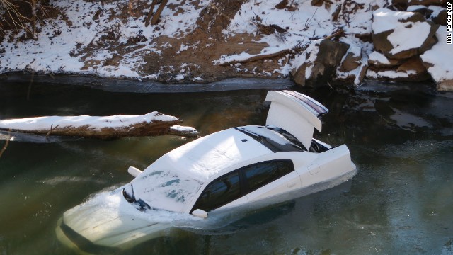 A car lies half submerged in the Cahaba River in Mountain Brook, Alabama, on Thursday, January 30. The driver was able to escape before the car slid into the river during a snow storm on Tuesday and was not injured. A wave of arctic air that started over the Midwest and Plains spread to the Southeast, bringing snow, freezing ice and sleet to a region that doesn't deal with such weather very often.