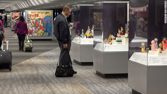 Astro Boy captures the attention of an SFO Terminal 3 traveler. Museum exhibits are becoming the norm at many U.S. airports, but San Francisco's is the only one accredited by the American Alliance of Museums.