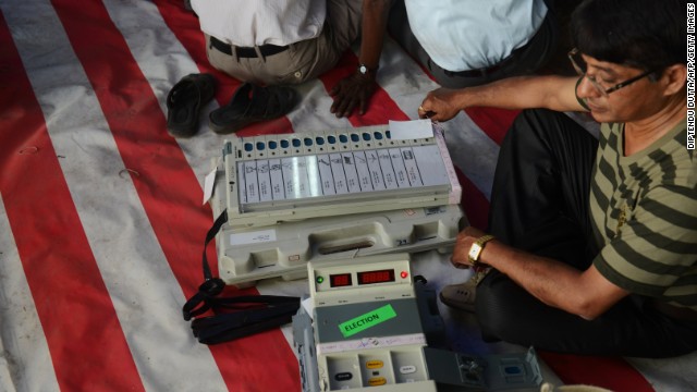 An election official checks an electronic voting machine before taking it to polling stations at a distribution center in Siliguri, India, on Wednesday, April 16. 