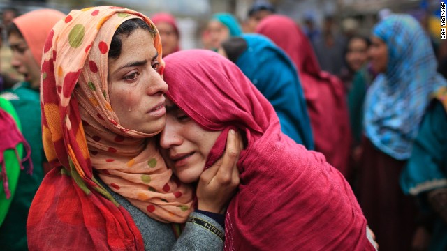 Unidentified relatives cry during the funeral procession of Zia-Ul-Haq in Hirpora on April 25.