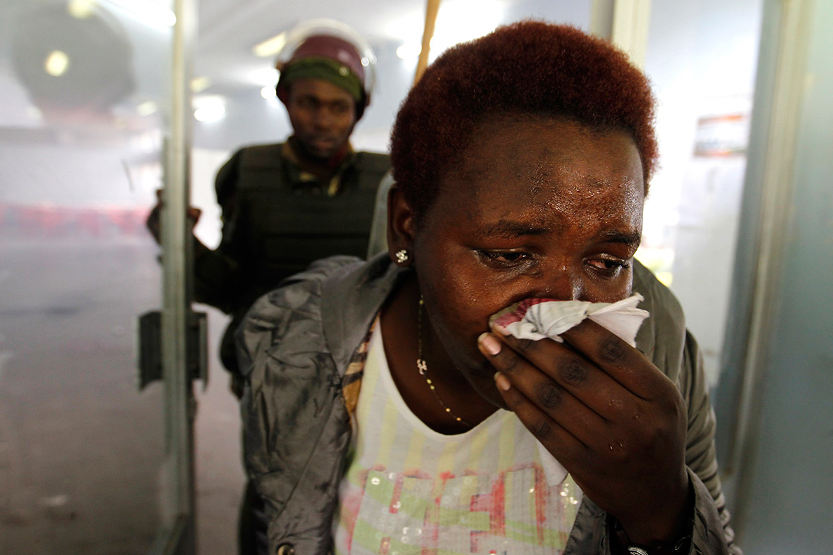 A University of Nairobi student suffering from the effects of tear gas surrenders to police