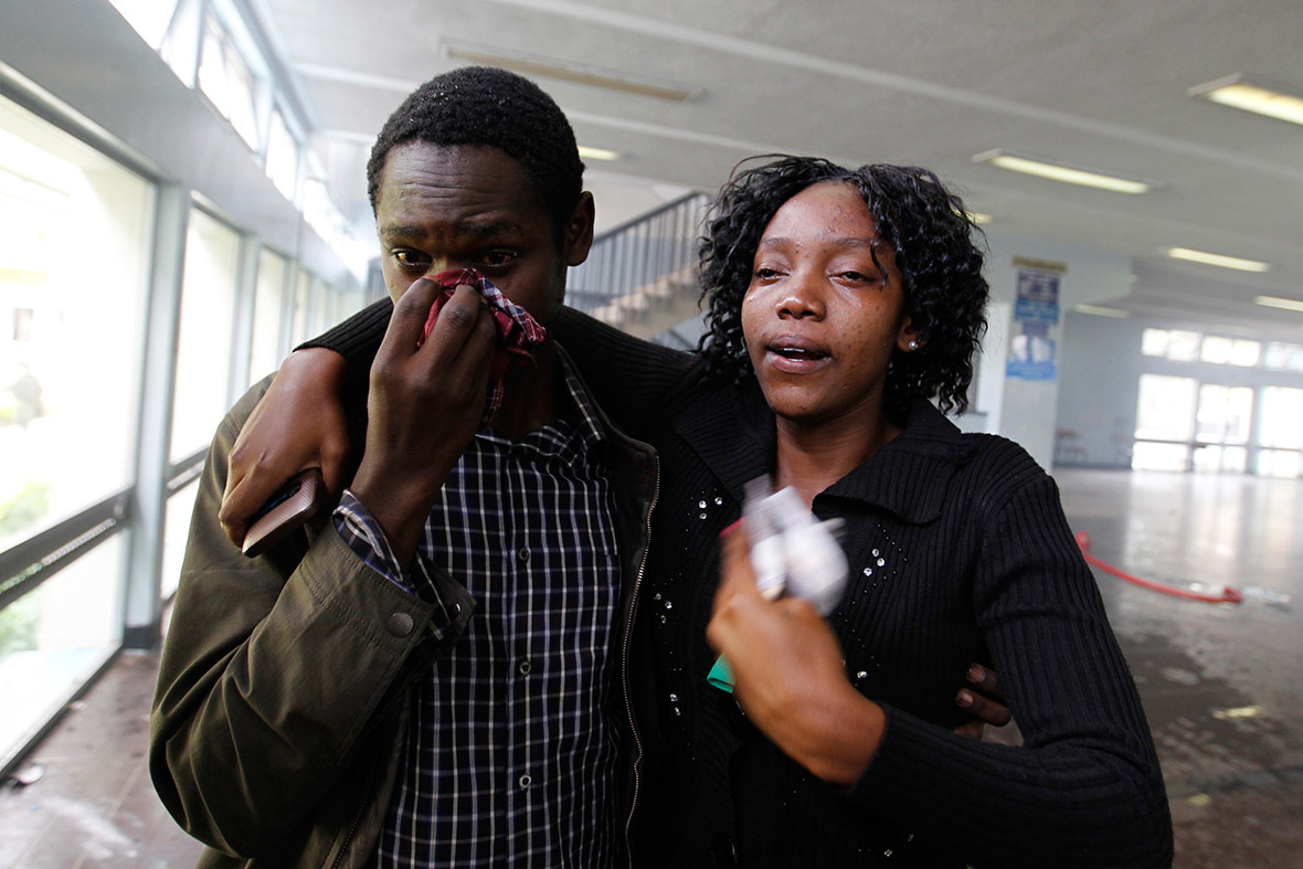 Students cry after police released tear gas to disperse them inside their lecture rooms at the University of Nairobi