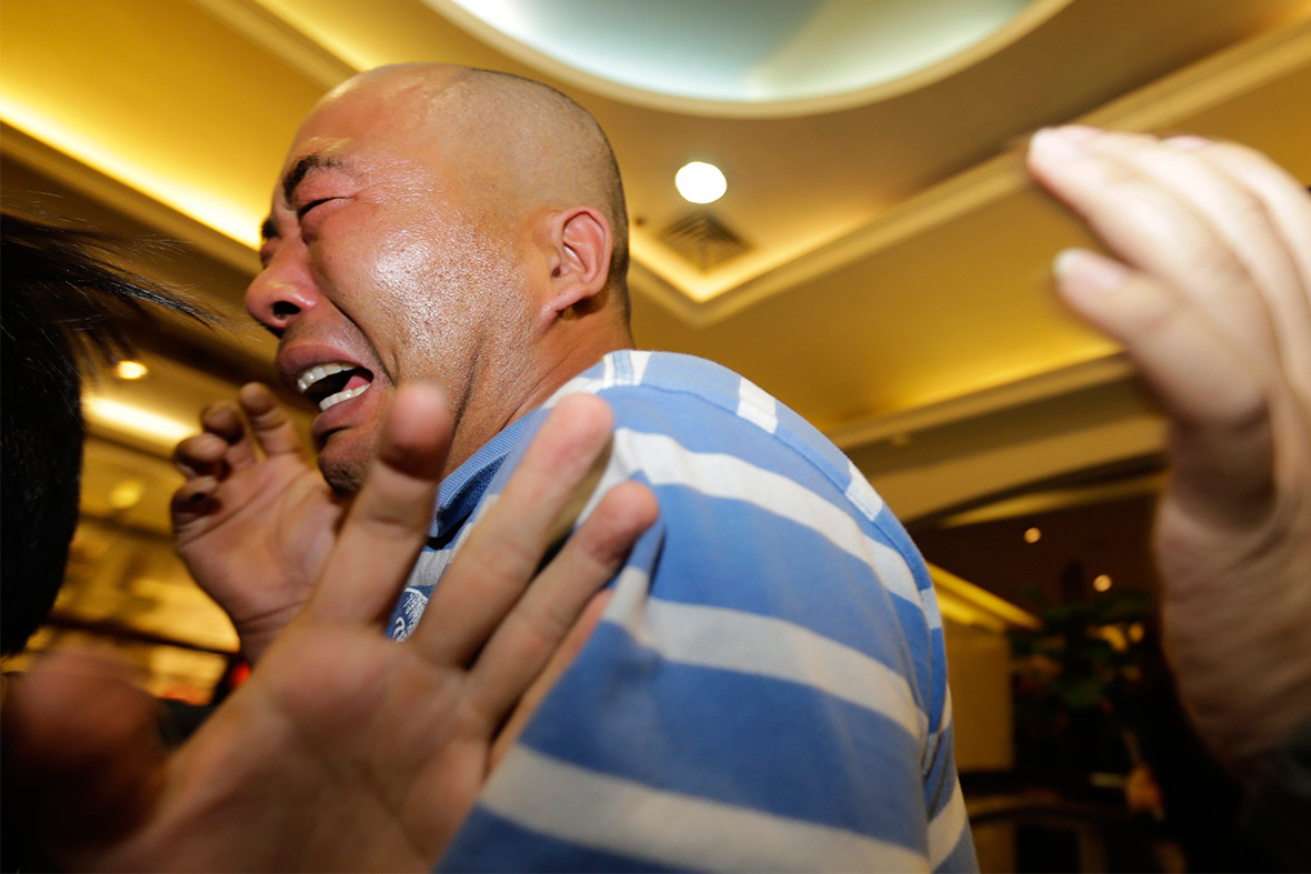 Relatives of passengers aboard Malaysia Airlines MH370 cry after Malaysian Prime Minister Najib Razak said that the plane ended its journey in the Southern Indian Ocean