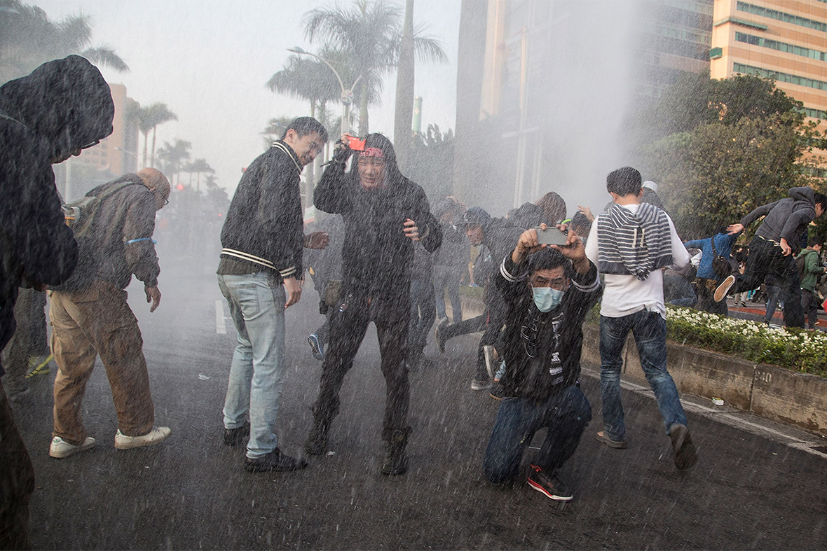 March 24, 2014: Student protesterssoaked by police water cannon
