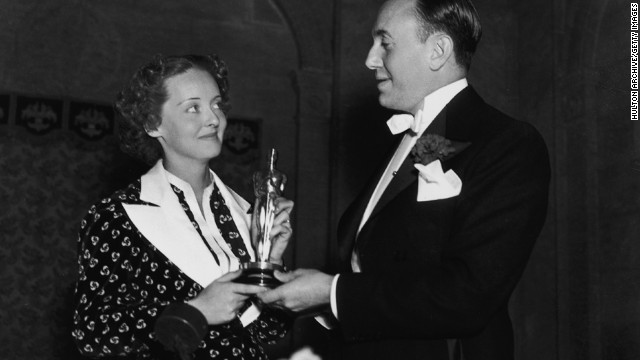Bette Davis and film producer Jack L. Warner hold Davis' best actress Oscar at the ceremony held in 1936. Davis won her first Oscar for her role in the film "Dangerous."