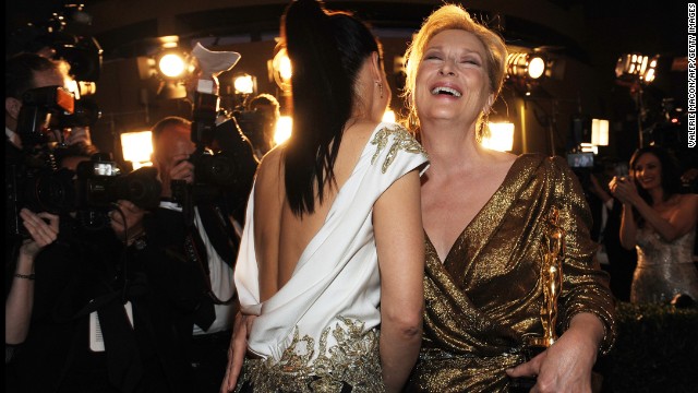Meryl Streep, right, laughs with Sandra Bullock after Streep's win for her role in "The Iron Lady."