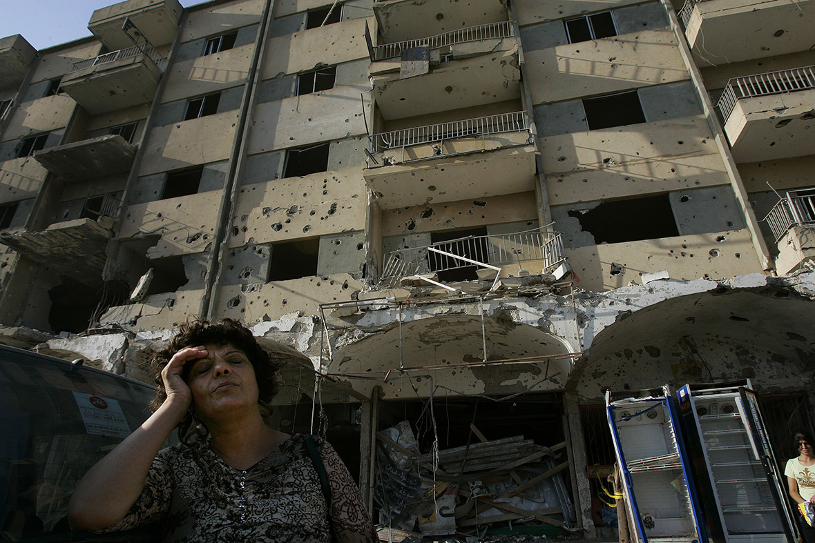 August 25, 2006: A woman cries in front of a damaged apartment block in Bint Jbail, Lebanon. Thousands of Lebanese people were left homeless after the 34-day battle between Hezbollah guerillas and Israeli forces