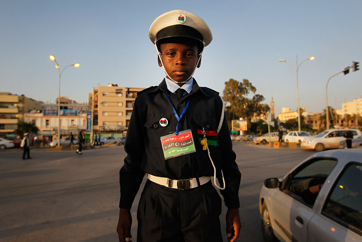 April 15, 2011: Ali Salem el-Faizani, 10, works as a traffic cop in Benghazi, Libya. Schools were closed throughout eastern Libya due to the ongoing civil conflict, so some children found work to pass the time