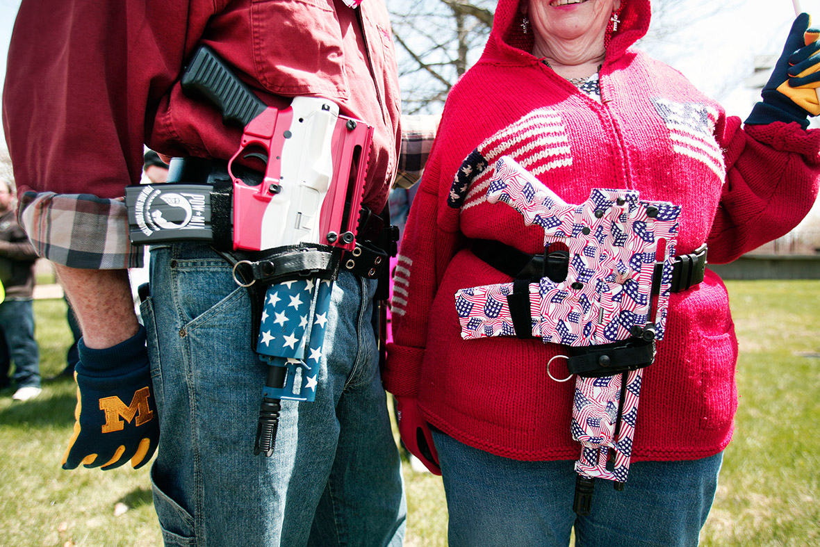 Chris and Marty Welch of Cadillac, Michigan, carry decorated Olympic Arms .223 pistols at a rally for supporters of the Open Carry law in Romulus, Michigan.
