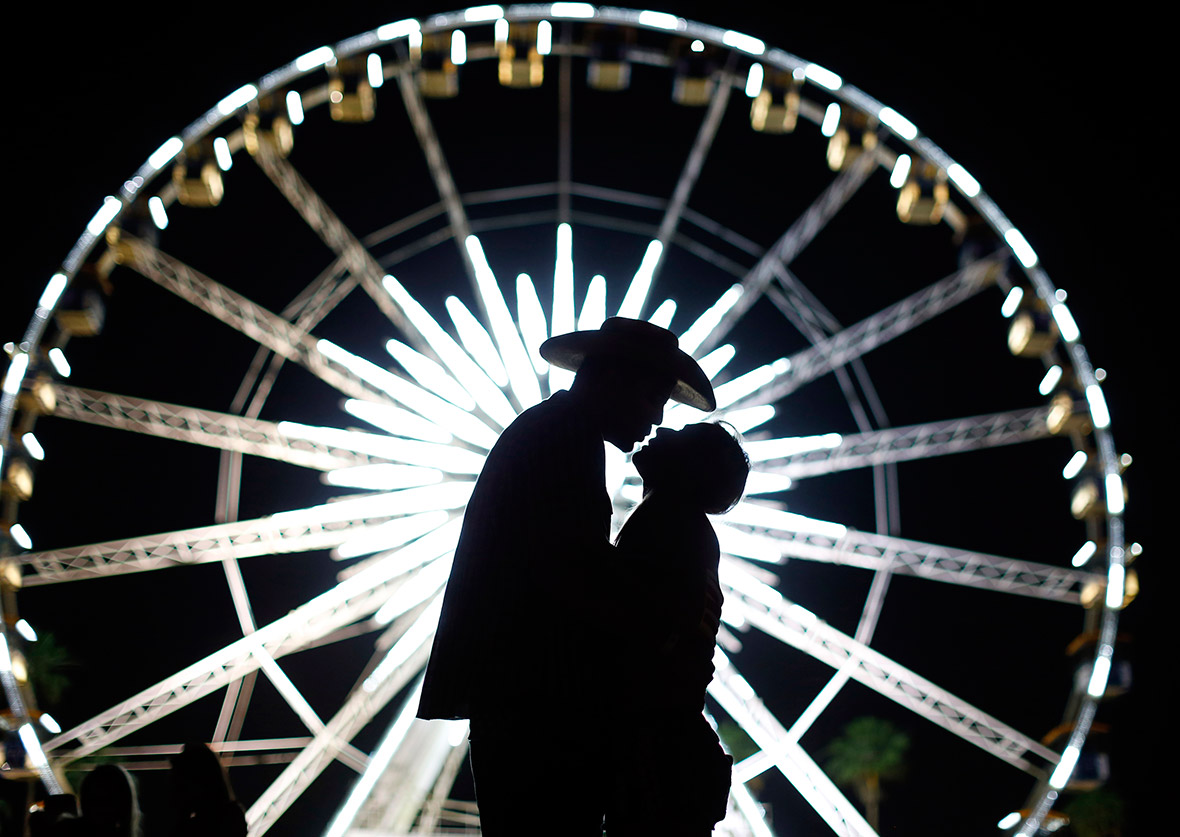 Cody Buijnink gives his girlfriend Kristen Dillon a kiss under the ferris wheel on the first day of the Stagecoach country music festival in Indio, California