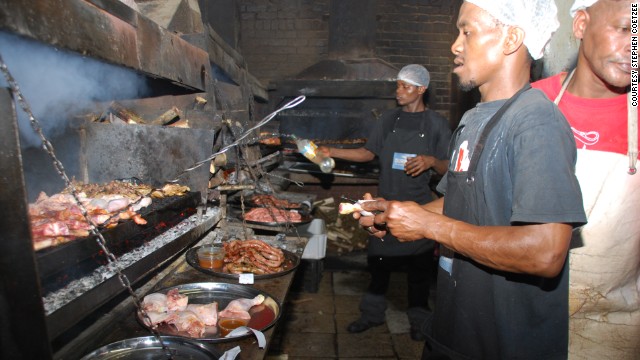 The South African version of the barbecue -- the "braai" -- is a strong tradition in the country. This picture shows workers on the braai line in the kitchen at Mzoli's in Cape Town.