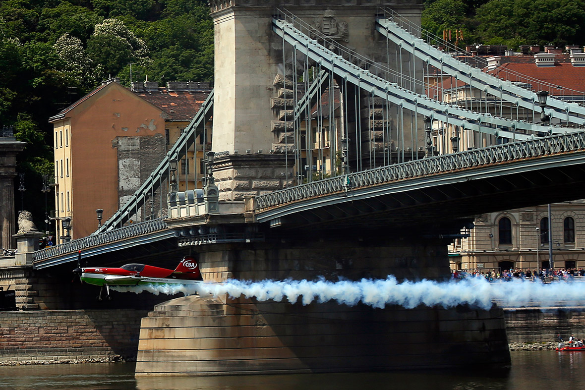Zoltan Veres of Hungary flies his MXS plane under Budapest's Chain Bridge during an air show