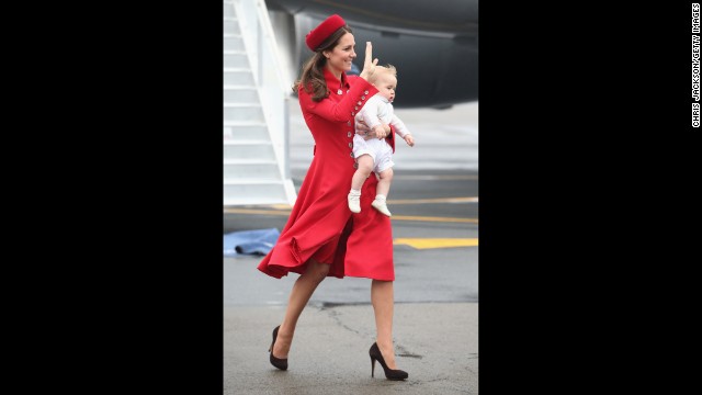 Catherine carries Prince George as they arrive for the start of the tour.