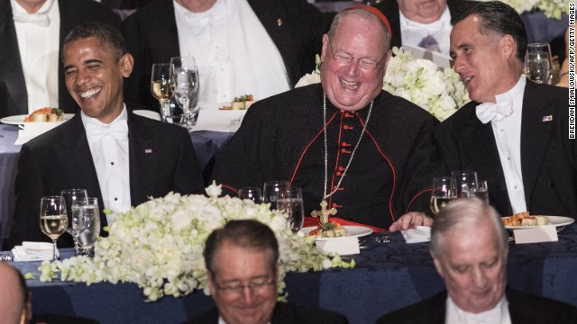 Obama, Cardinal Timothy Dolan, and Republican presidential opponent Mitt Romney during the annual Al Smith Dinner in New York on October 18, 2012, in New York. Obama poked fun at Romney and himself, saying he was "well-rested" from a "long nap" during the pair's first debate.