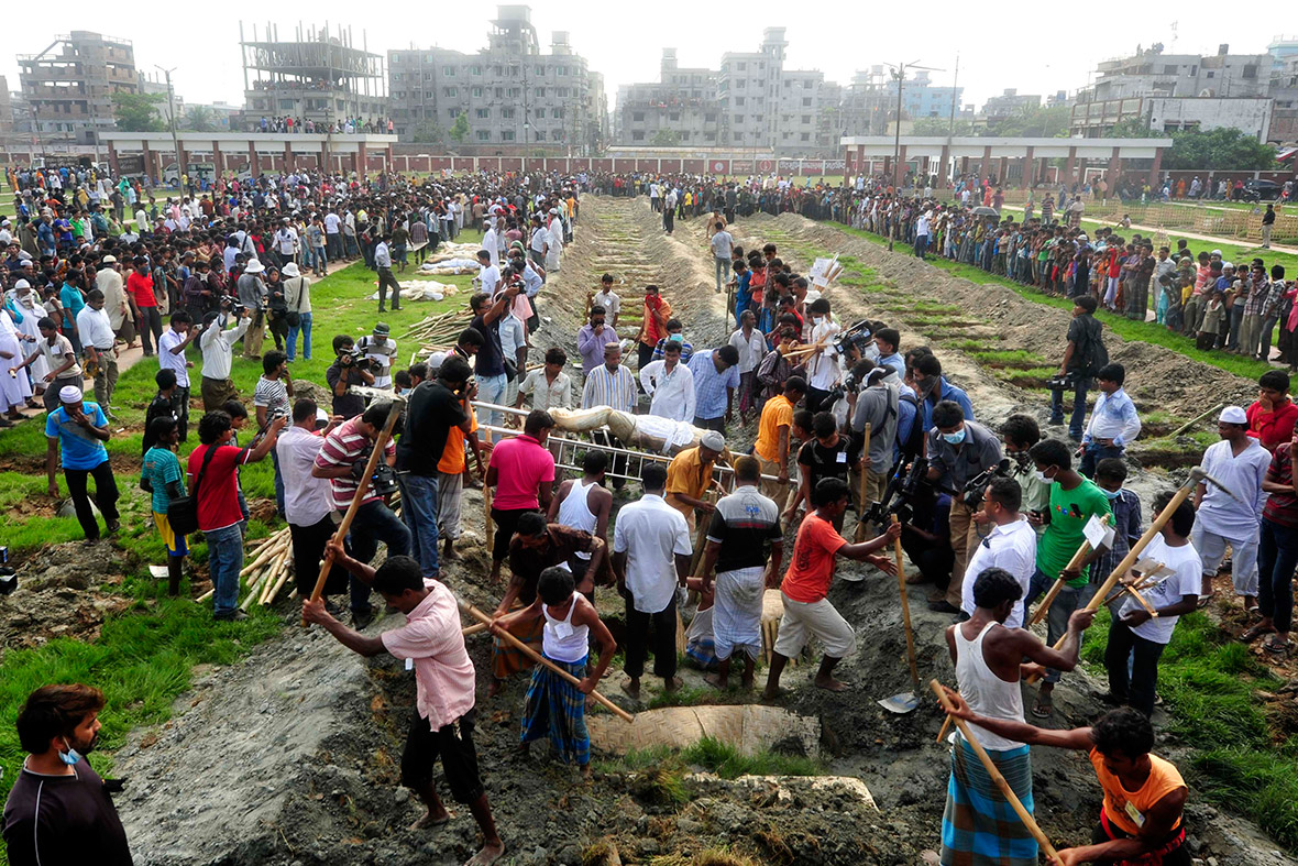 May 1, 2013: Workers dig graves during a mass burial of unidentified garment workers who died in the collapse of the Rana Plaza building