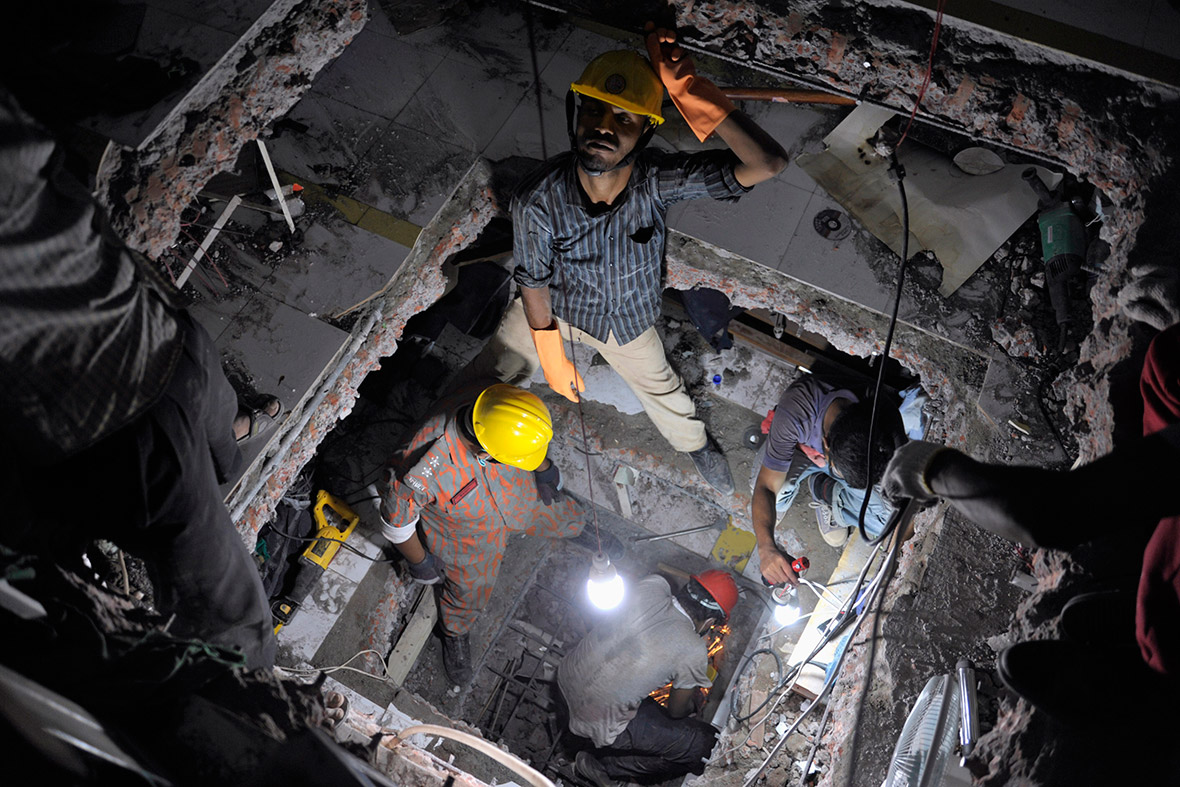 April 28, 2013: Rescue workers search for garment workers trapped under the rubble