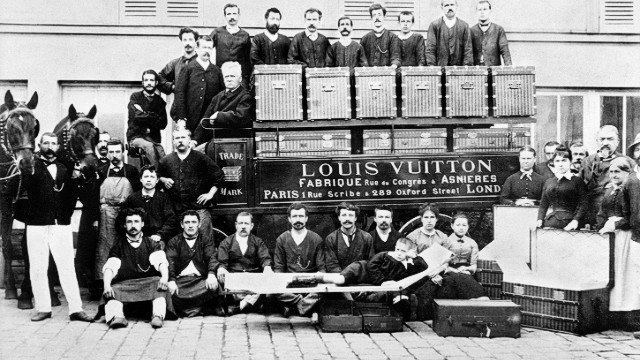 Since its founding in Paris in 1854, the Louis Vuitton company catered to the more glamorous-minded members of society, including empresses, explorers and artists. In this photo from 1888, Louis Vuitton's son Georges and grandson Gaston-Louis pose with factory workers in front of a horse-drawn delivery van.